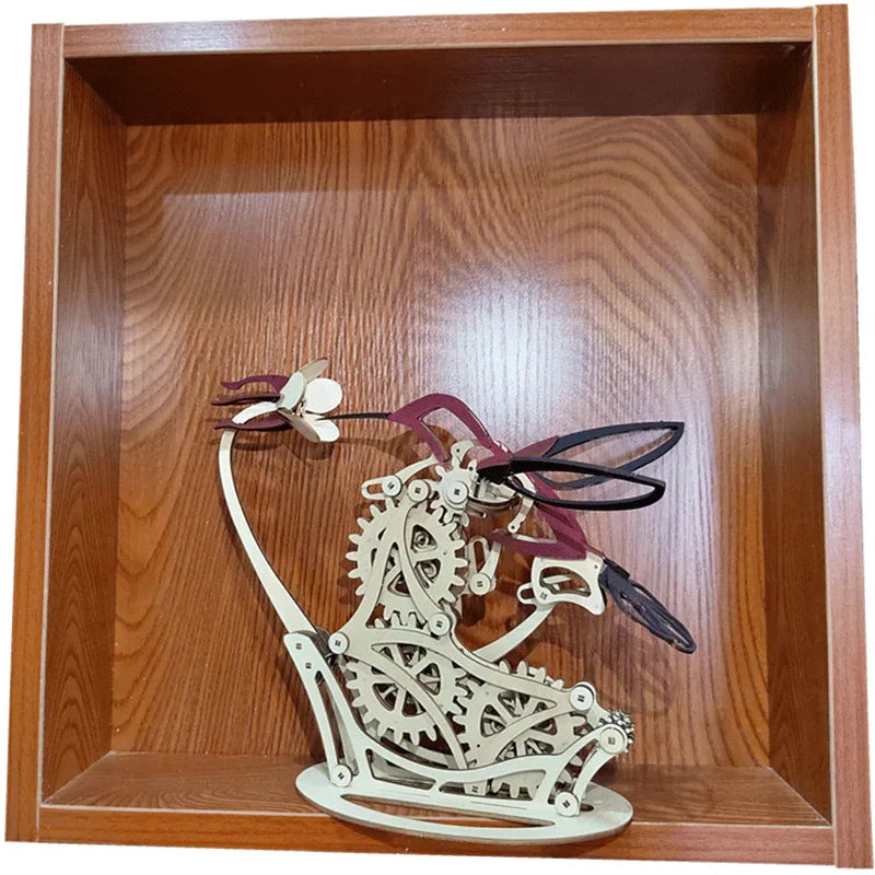 kinetic bird sculpture displayed in cube shelf, wooden mechanical hummingbird art object and conversation piece