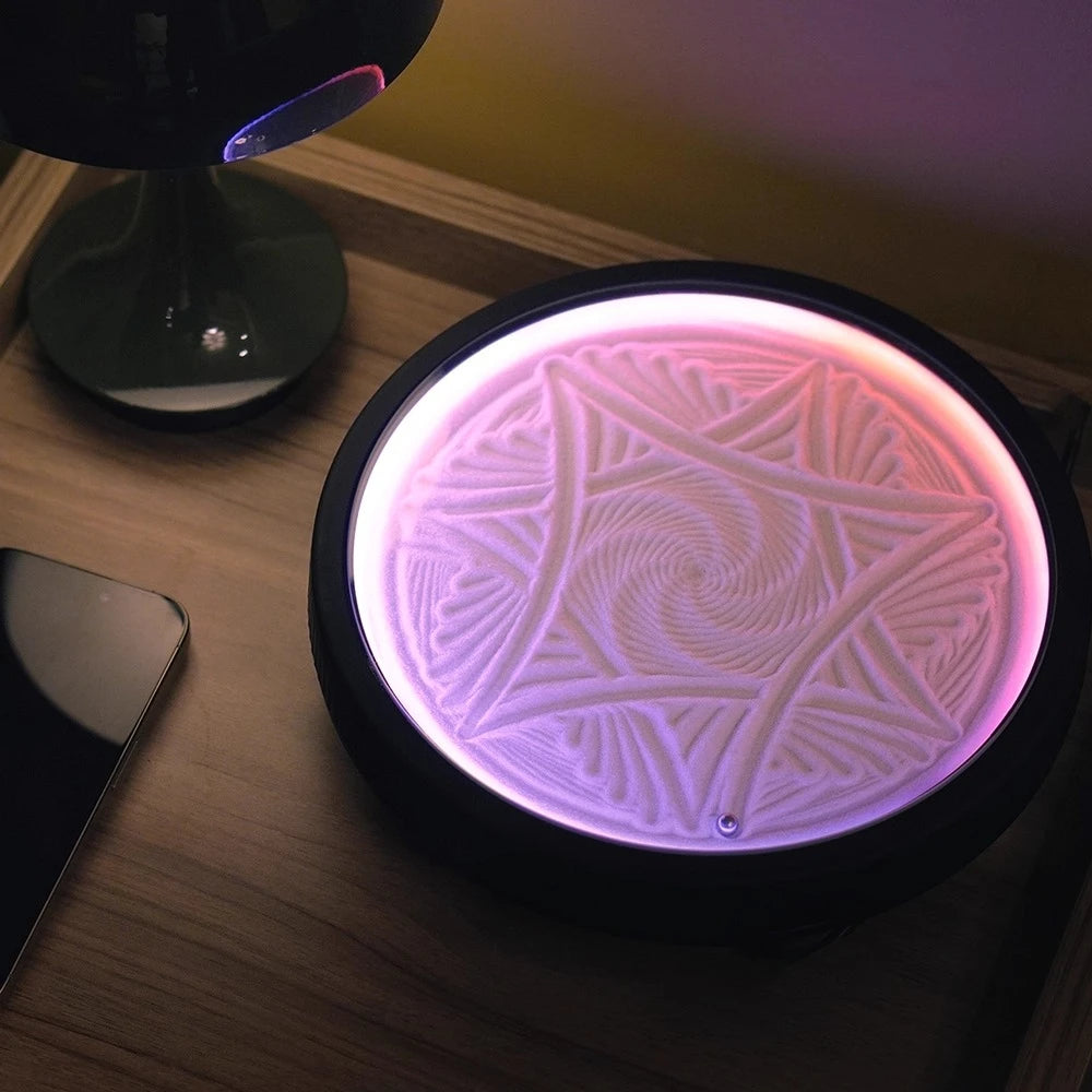 kinetic sand drawing table glowing as a bedroom night light, calming zen sand patterns for relaxation on a nightstand or shelf