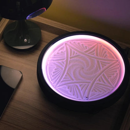 kinetic sand drawing table glowing as a bedroom night light, calming zen sand patterns for relaxation on a nightstand or shelf