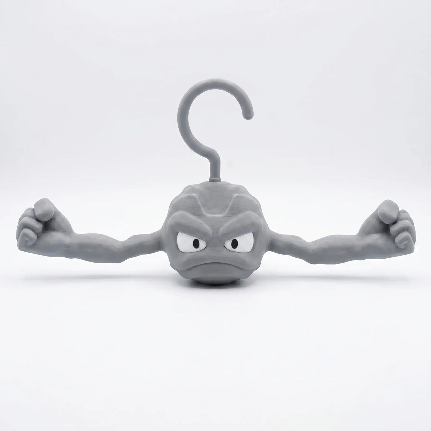 3D printed Pokemon Geodude hanger front view with muscled arms outstretched, rock monster coat hanger for Pokemon fans