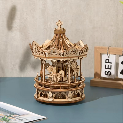 Wooden carousel model on a table with a neutral background