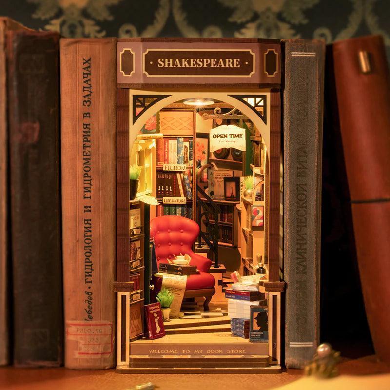 literary book nook diorama with tiny folios, quill pen and scrolls, shakespeare themed bookshelf decor idea