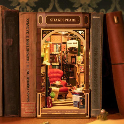 literary book nook diorama with tiny folios, quill pen and scrolls, shakespeare themed bookshelf decor idea