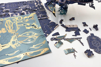 wooden ship puzzle parts sheets and pressed out pieces laid out before assembly with no glue needed, Blue, Gold