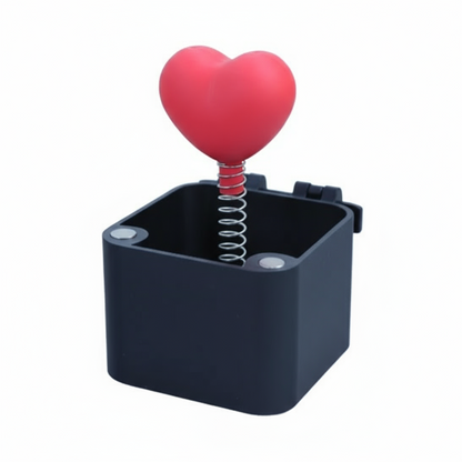 Black box with a red heart-shaped object on top against a white background