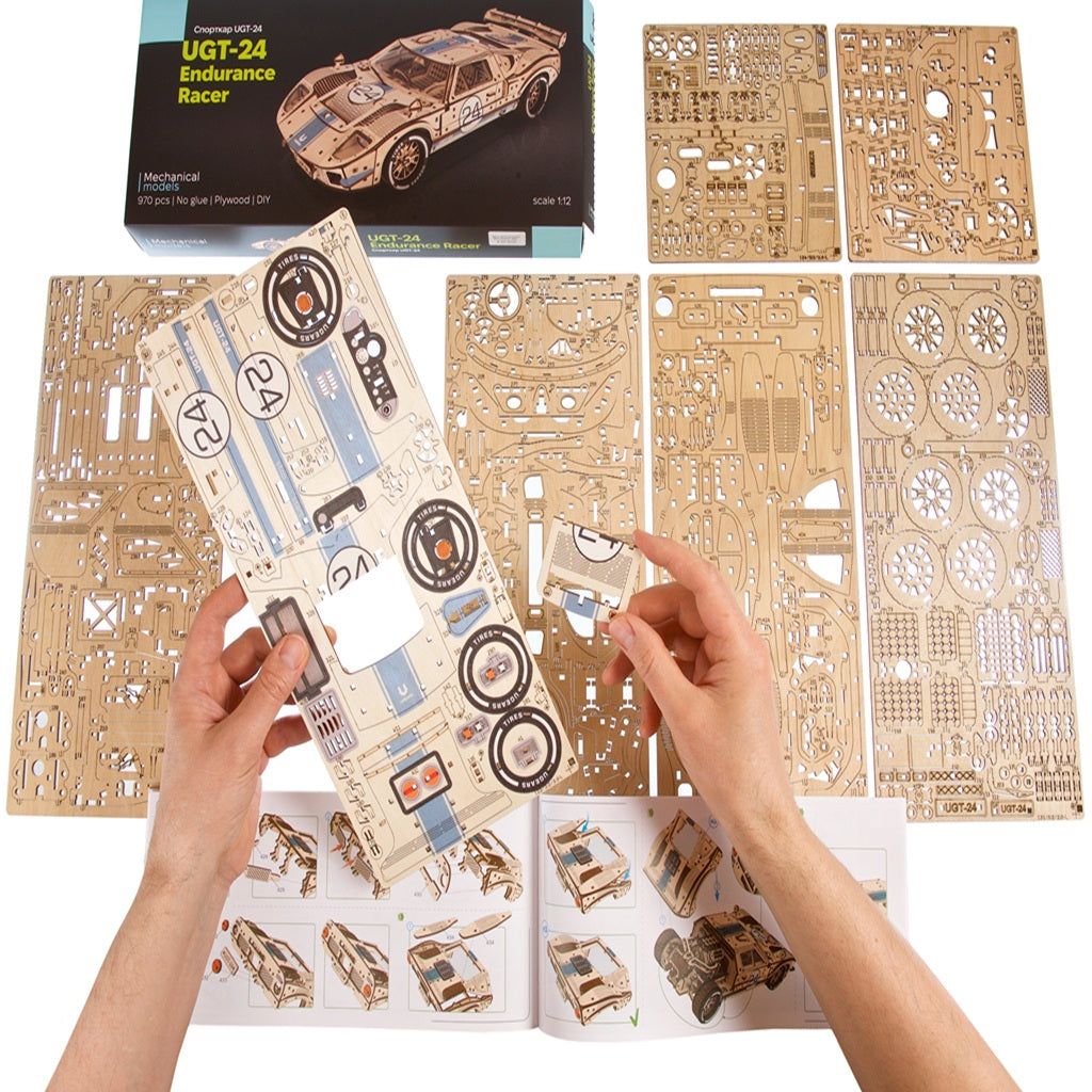 hands assembling laser cut wooden model kit parts, hands on car building hobby away from screen time