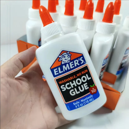 Elmer's School Glue bottle held by a hand with more glue bottles in the background. ELMERS-1 ELMERS-2 ELMERS-3 ELMERS-4
