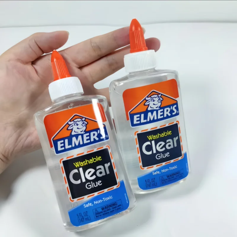 Two bottles of Elmer's clear glue held by a hand on a white background ELMERS-1 ELMERS-2 ELMERS-3 ELMERS-4