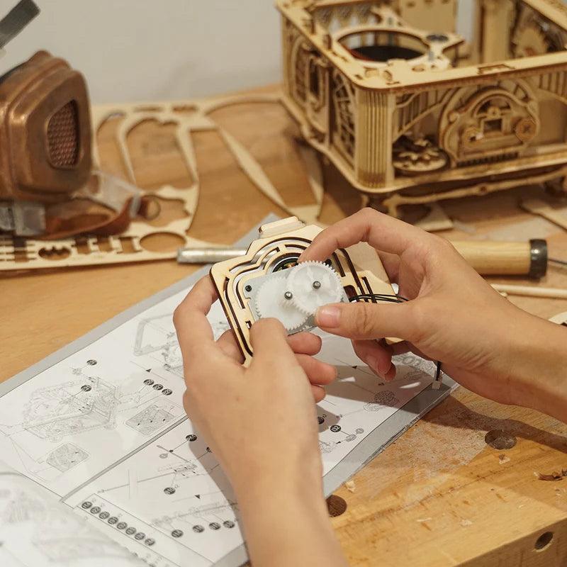 wooden gramophone record player kit assembly hands holding gear mechanism DIY adult build mechanical model