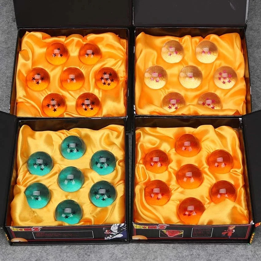 Four boxes containing colorful spherical items on a gray surface