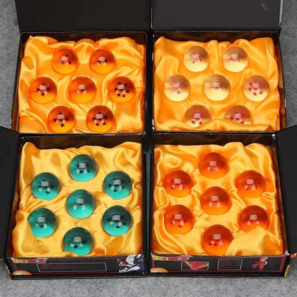 Four boxes containing colorful spherical items on a gray surface