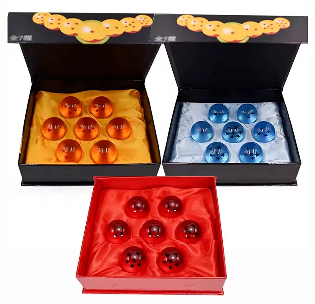 Three boxes containing Dragon Ball Z crystal orbs collectible set with star patterns in orange red and blue colors