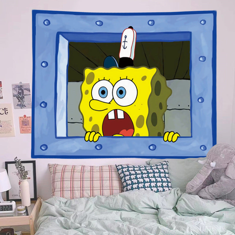 Cartoon character tapestry hanging on a wall above a bed with colorful pillows.